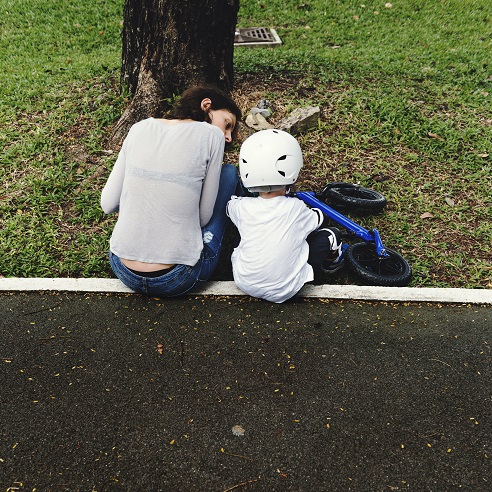 Mom Teaching Son Biking at Park Outdoors